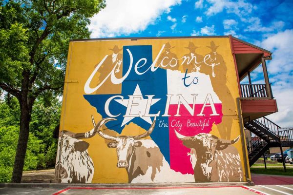 Colorful mural welcoming visitors to Celina, Texas, featuring longhorn cattle and Texas flag colors.