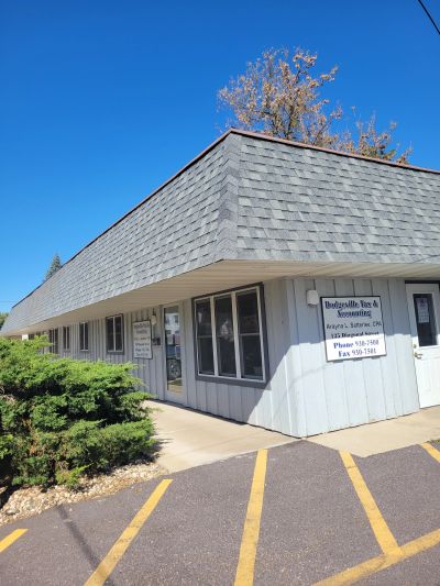Small office building with signage on the wall.