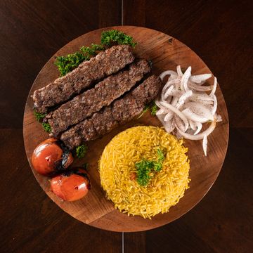 Beef Kebab
Three freshly prepared ground beef skewers seasoned and cooked over charcoal. Served on a