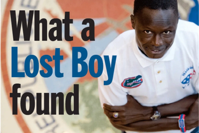 A Sudanese boy looks up next to the title