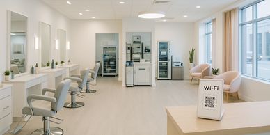 Modern, bright hair salon with styling chairs and a Wi-Fi sign.