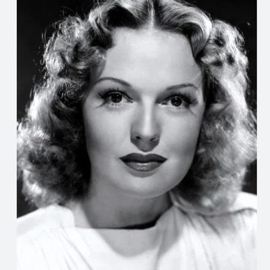 Classic black-and-white portrait of a woman with styled curls and elegant makeup.