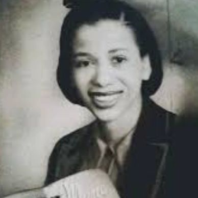 Black and white portrait of a smiling young woman.