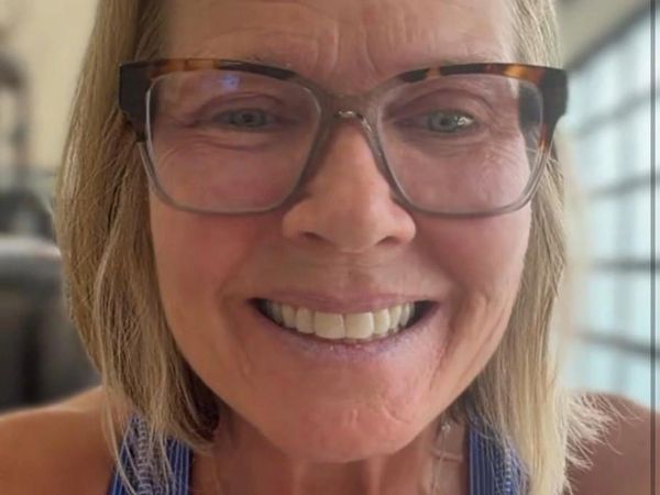 Close-up of a smiling woman with glasses.