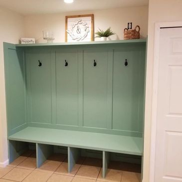 Backpack and coat storage area in mudroom.