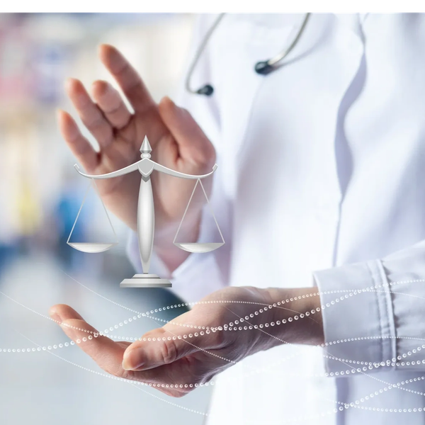 Doctor holding symbolic scales of justice.