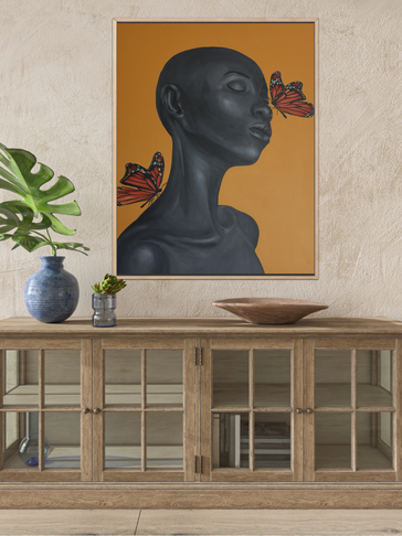 Black sculpture portrait with two monarch butterflies on an orange background.
