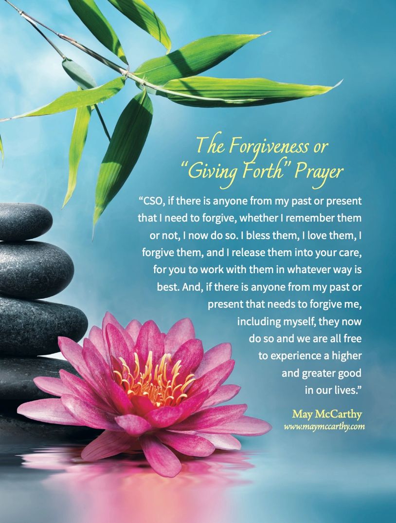 A peaceful scene with a forgiveness prayer, pink lotus, and balanced stones.