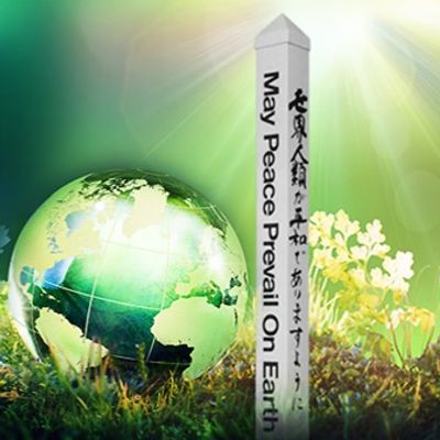A globe and a peace monument with the message 'May Peace Prevail On Earth'.