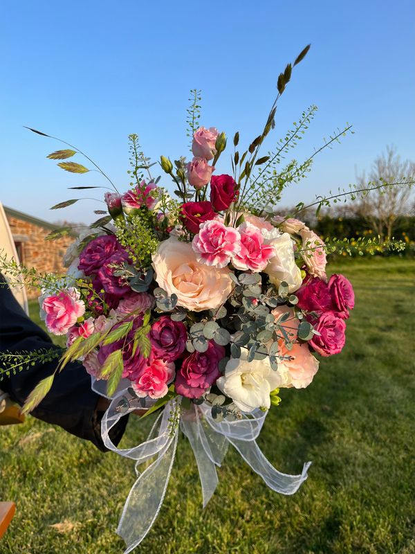 A bouquet of mixed pink and red flowers