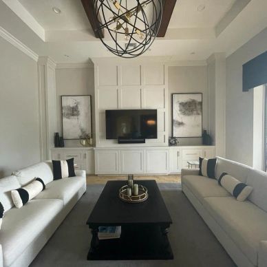 Modern living room with neutral tones and symmetrical layout.