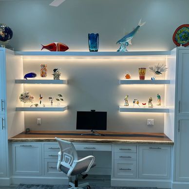 Well-lit workspace with glass art display.