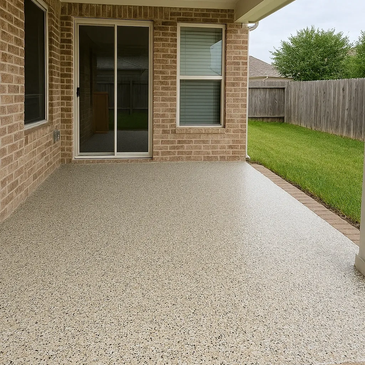 Covered patio with brick walls and a speckled concrete floor.