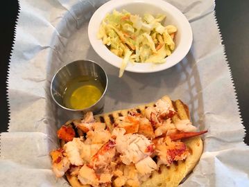 Hot Butter Lobster Roll, served w choice of slaw or chips and drizzling hot butter on the side.