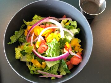 House Salad, Romaine, tomatoes, peppers, onion, shown here w balsamic vinaegrette.
