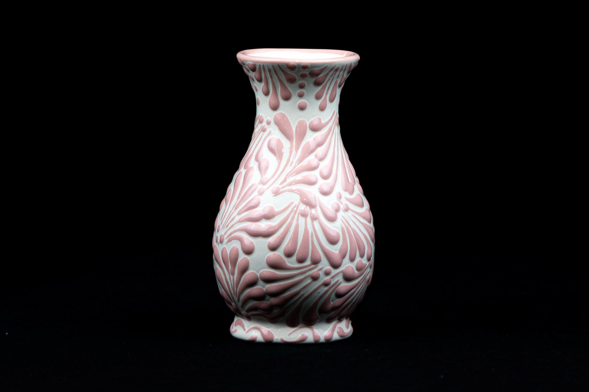 Decorative vase with pink textured patterns on white background.