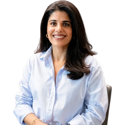 Smiling woman in a light blue shirt sitting.