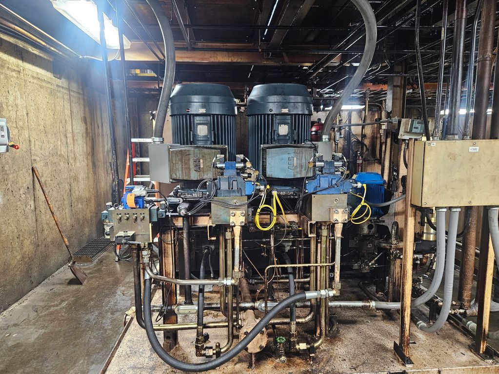 Industrial machinery with motors and pipes in a factory setting.