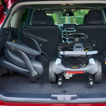 carryon scooter loaded into car trunk
