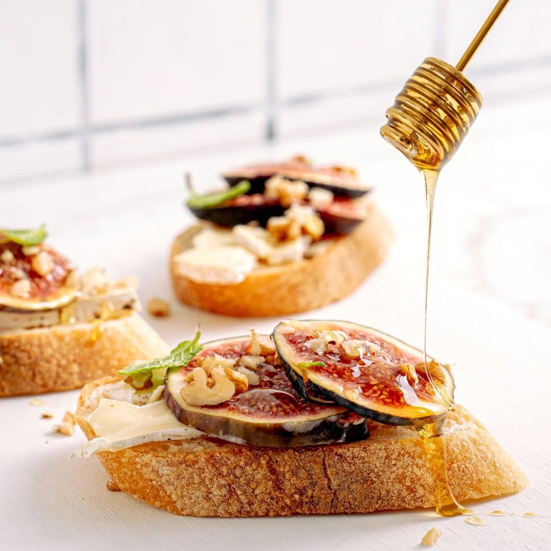Honey drizzled on bread and figs. Food, hospitality, restaurants, beverage, drinks, bars.