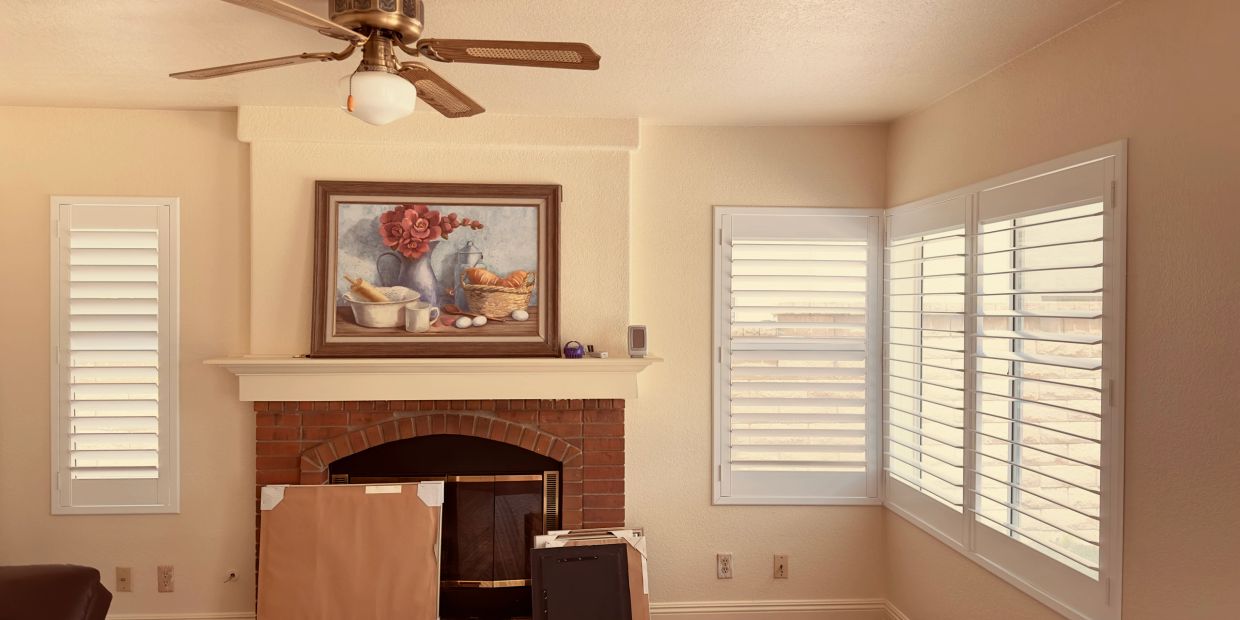 Cozy living room with a brick fireplace and floral painting above it.