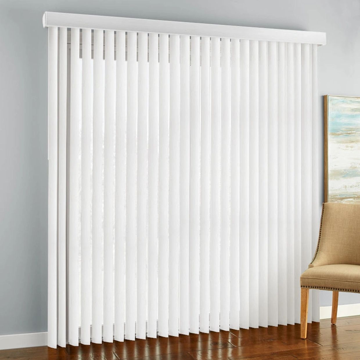 White vertical blinds covering a window in a modern room.