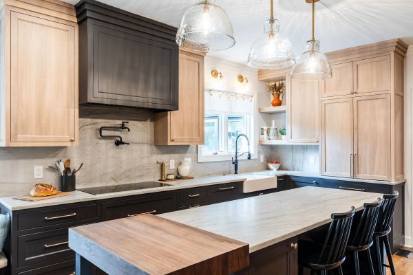 Modern kitchen with wood and black cabinetry and large island.