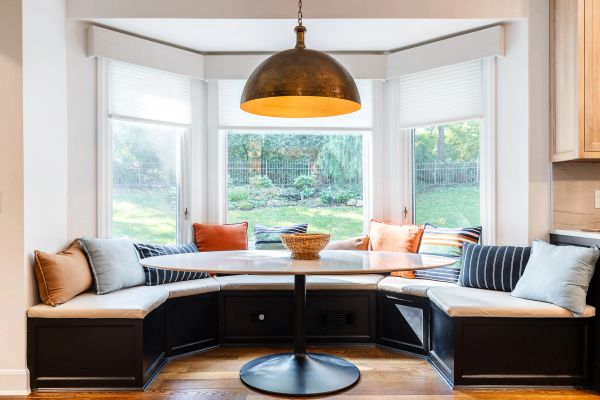 Cozy breakfast nook with built-in bench seating and pendant light.