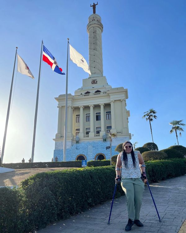 Johileny in crutches in front of Dominican Republic Santiago Monument.