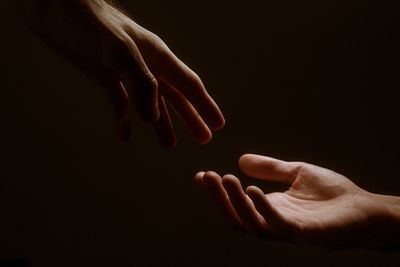 Two hands reaching for each other