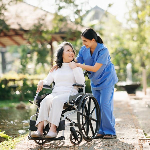 Home Care worker looking after a patient while on a walk.