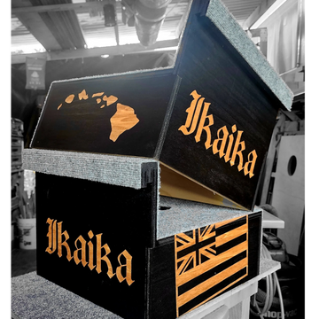 Black wooden boxes with Hawaiian-themed designs and the word 'Ikaika'.