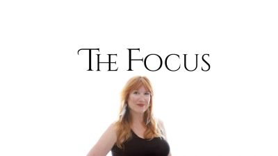 Woman posing confidently under the text "The Focus".