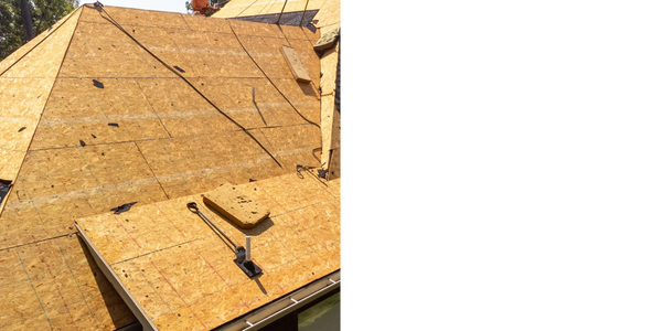 Roof under construction with plywood sheets being installed.