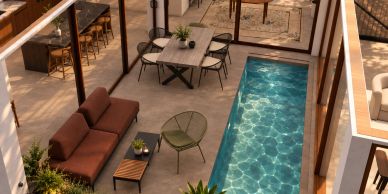 Modern patio with pool and seating area.