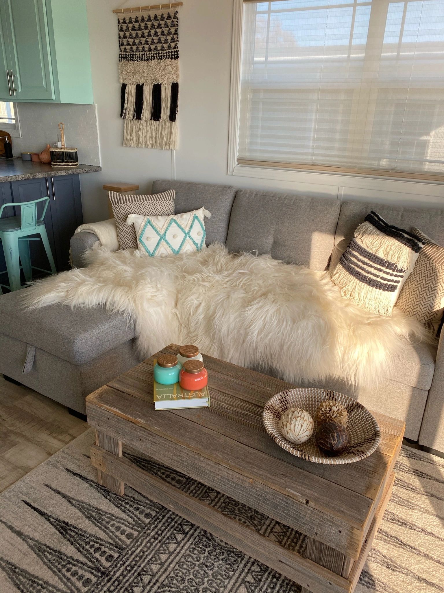 Cozy living room with gray couch and rustic table.