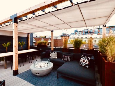 Cozy outdoor seating area with modern decor and city view.