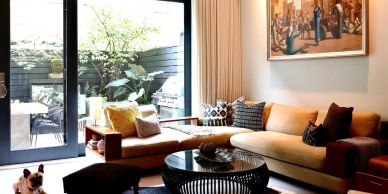 Cozy living room with L-shaped couch and large window.