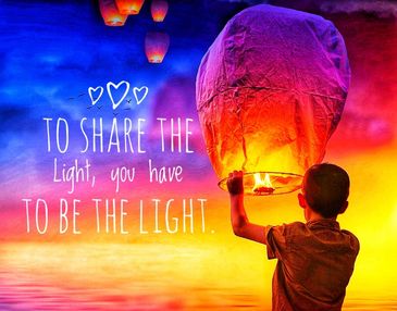 Child holding lantern about to let it go into the sky over the ocean