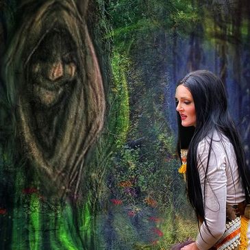 Woman dressed as Pocahontas sitting in a forest next to a tree with a face.  