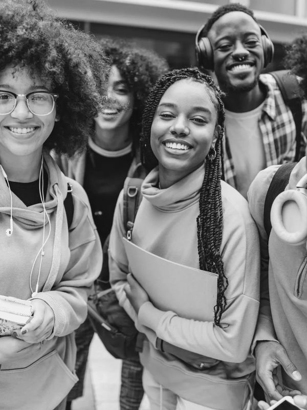 Group of happy young students smiling outdoors.