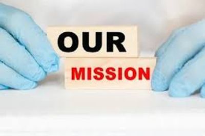 Hands in gloves holding blocks spelling 'OUR MISSION'.