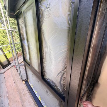 Windows covered during painting preparation.