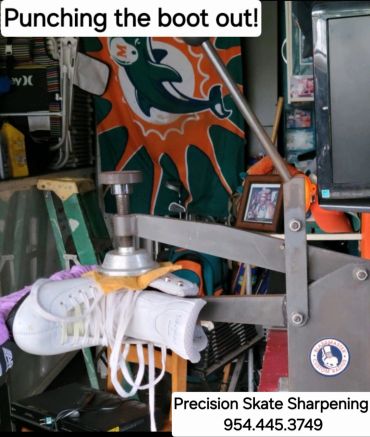 Machine sharpening ice skates in a workshop.
