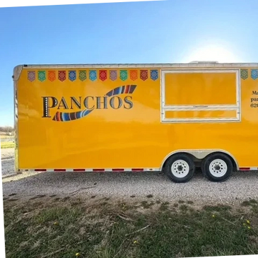 Bright yellow food truck named Panchos with colorful decorations.