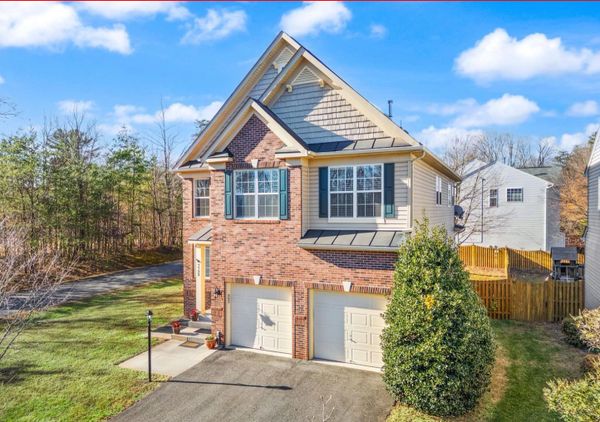 Two-story suburban house with brick and siding exterior and a double garage.
