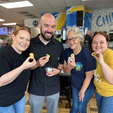 Happy SunStop Convenience Store team members enjoying Grab n Go Snacks