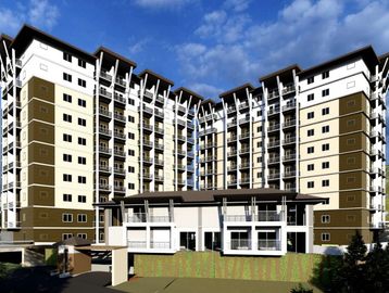 Modern multi-story apartment building under a blue sky.