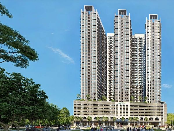 Modern high-rise residential buildings with clear blue sky.
