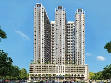 Tall modern residential building under blue sky.